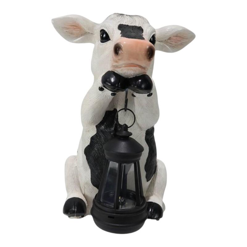 Cow-shaped lantern with a black bow tie on a white background