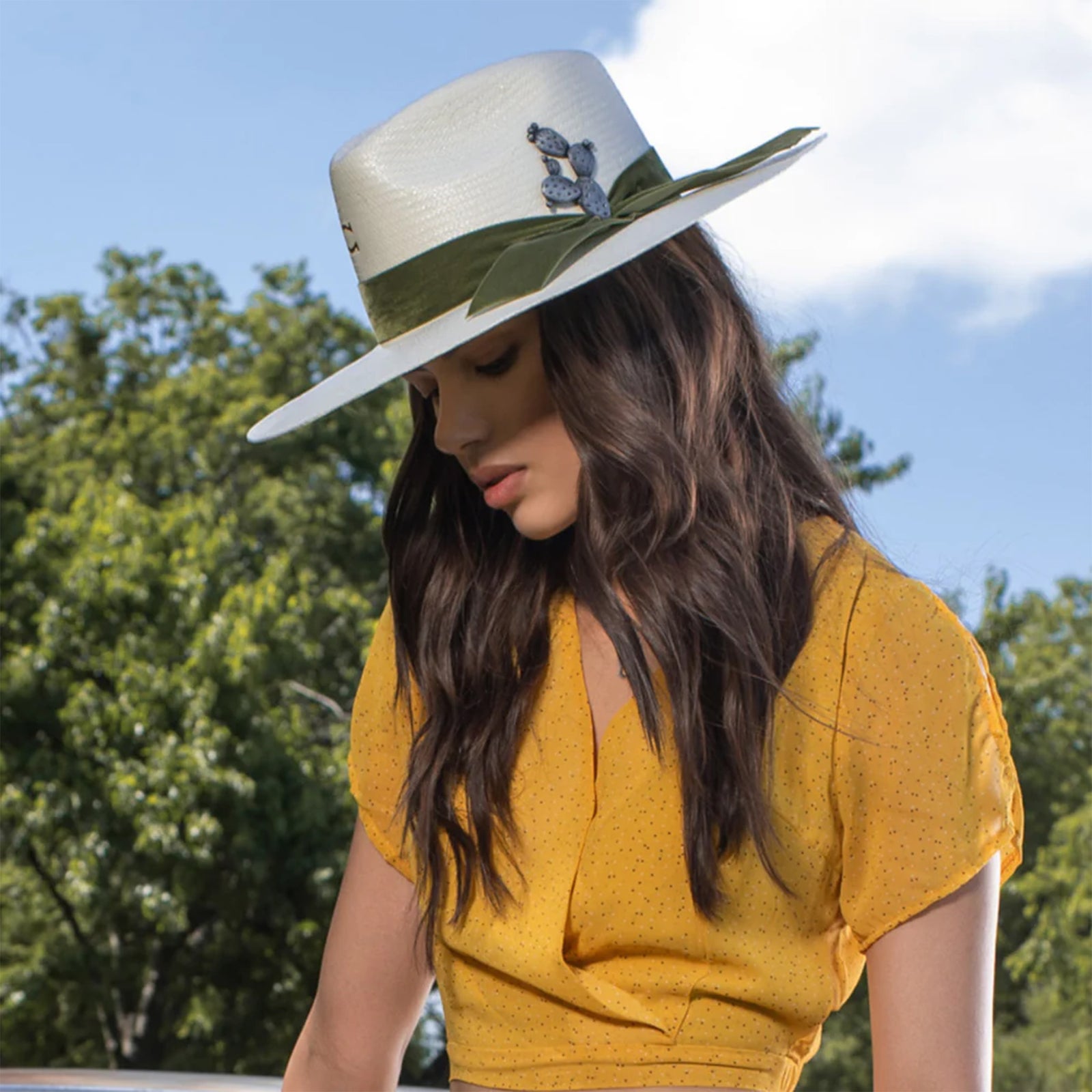 Charlie 1 Horse Hard To Handle Straw Cowboy Hat. A beige cowboy hat with an olive-green velvet ribbon and a cactus concho pin, featuring the 'Charlie 1 Horse' brand logo on the crown.