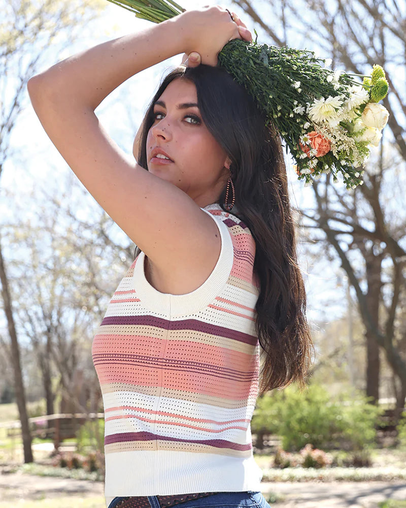 Woman holding a bouquet of flowers outdoors with trees in the background