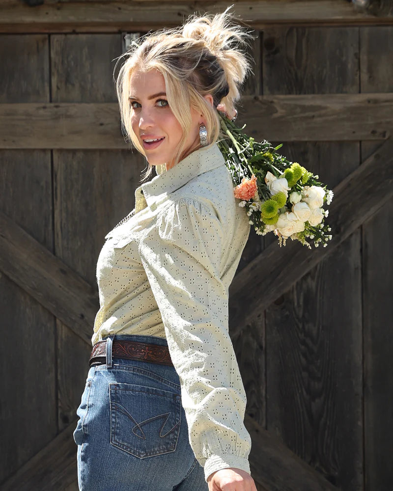 Woman holding a bouquet of flowers against a wooden background