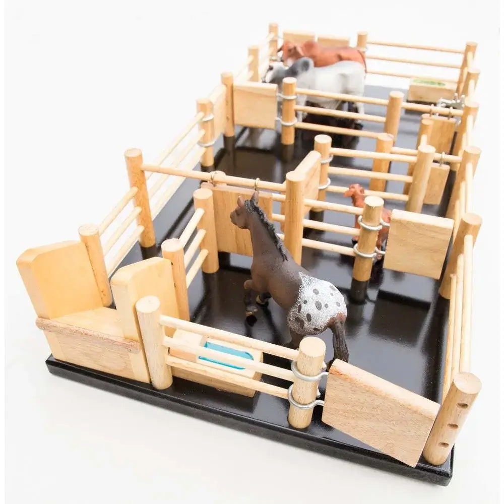 Country Toys CY3 Wooden Cattle Yards. Handmade wooden toy cattle yard with three exterior gates, three internal gates, and three sliding gates. Includes a ramp and a few toy cattle in different colors.