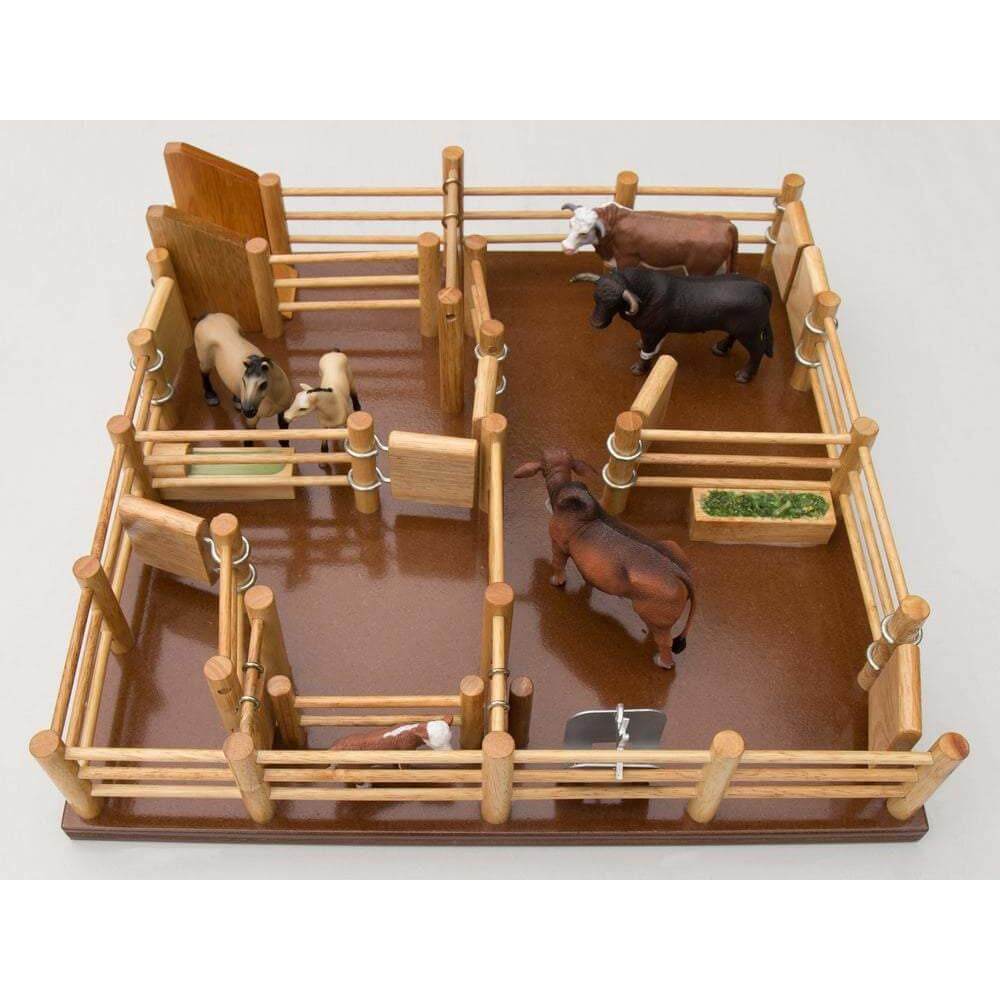 Country Toys CY4 Wooden Cattle Yards. Handmade wooden toy cattle yard with multiple gates, a feeding trough, water trough, and a metal branding cradle. Includes a ramp for loading cattle off a timber cattle truck (not included).