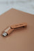 Here And Then Box - Burnt. Wooden USB drive with 'here:then' branding on a beige surface