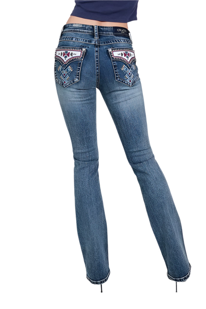 Grace In LA Women's Aztec Embroidery Jean. A pair of women's bootcut jeans with aztec embellishments on the back pockets and embroidered designs. The jeans are displayed on a model wearing black heels.