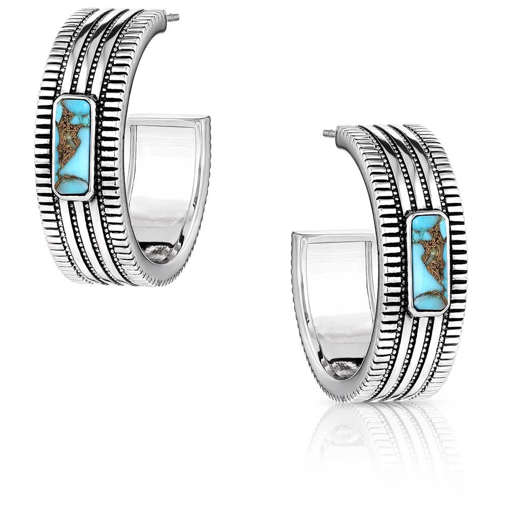 Montana Silversmiths Turquoise Sky Hoop Earrings. A pair of Montana Silversmiths Turquoise Sky Hoop Earrings with etched designs and black paint accents, featuring crafted turquoise stones.