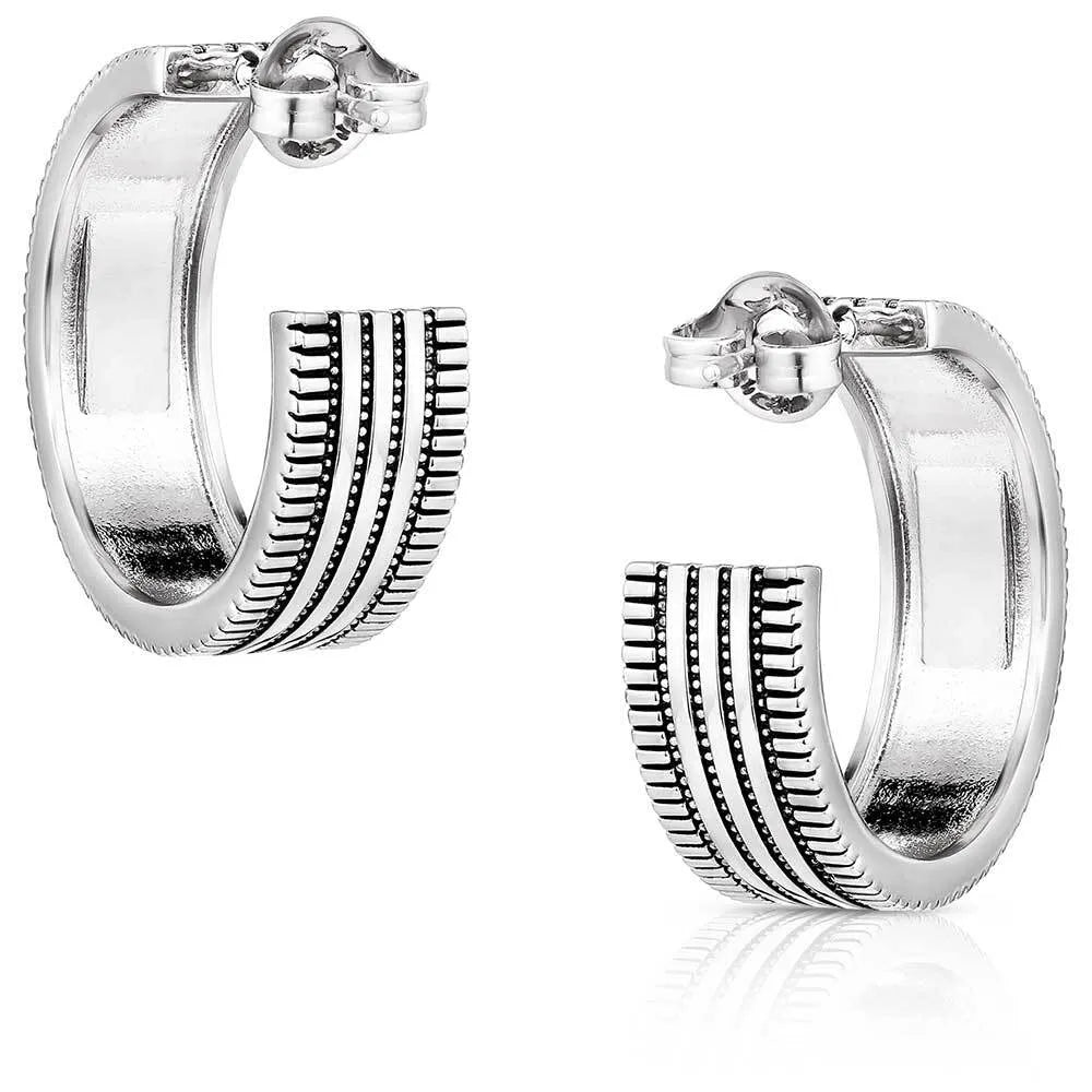 Montana Silversmiths Turquoise Sky Hoop Earrings. Pair of silver hoop earrings with textured design on a white background