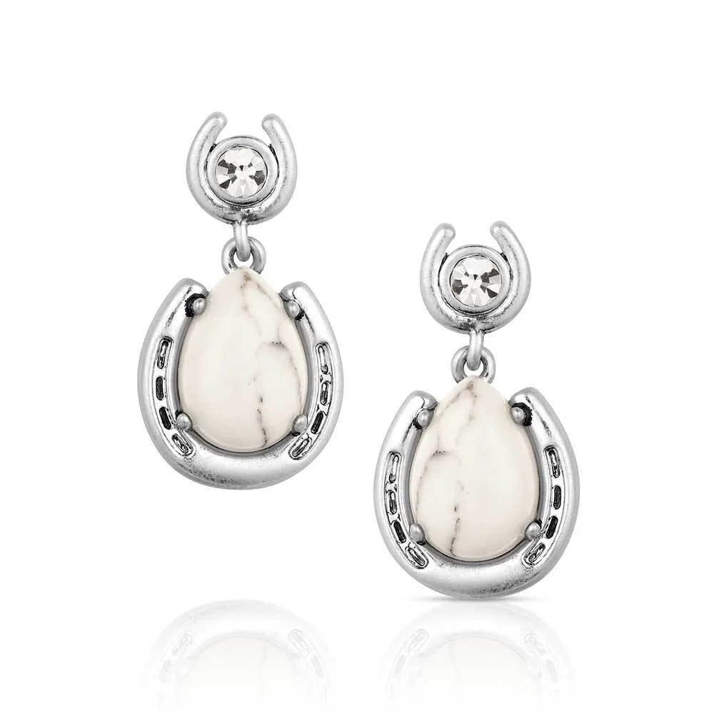 Silver earrings with white stones on a white background