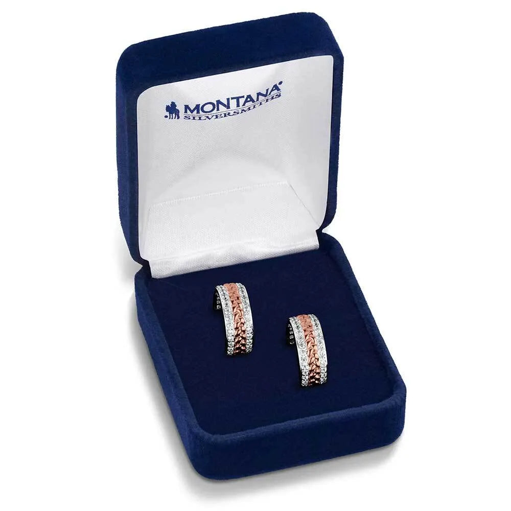 Rose gold earrings in a blue jewelry box with 'Montana Silversmiths' branding.