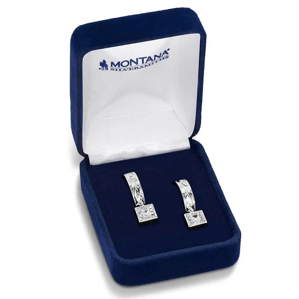 Silver earrings in a Montana Silversmiths box on a white background