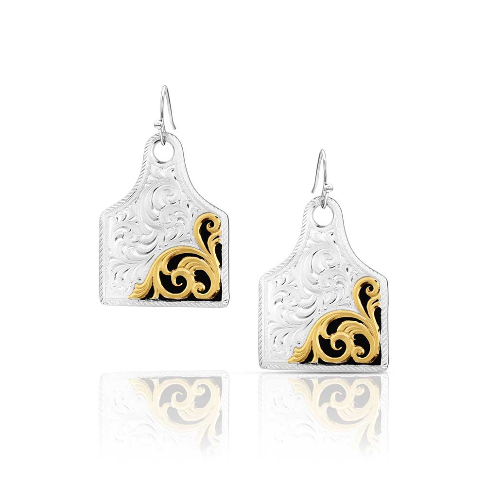 Pair of earrings with gold and black designs on a white background