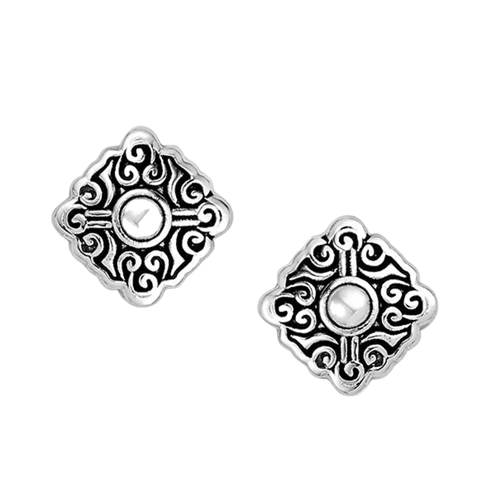 A pair of silver-toned square stud earrings with ornate filigree scrollwork and a central round bezel-set clear stone, shown on a plain white background.