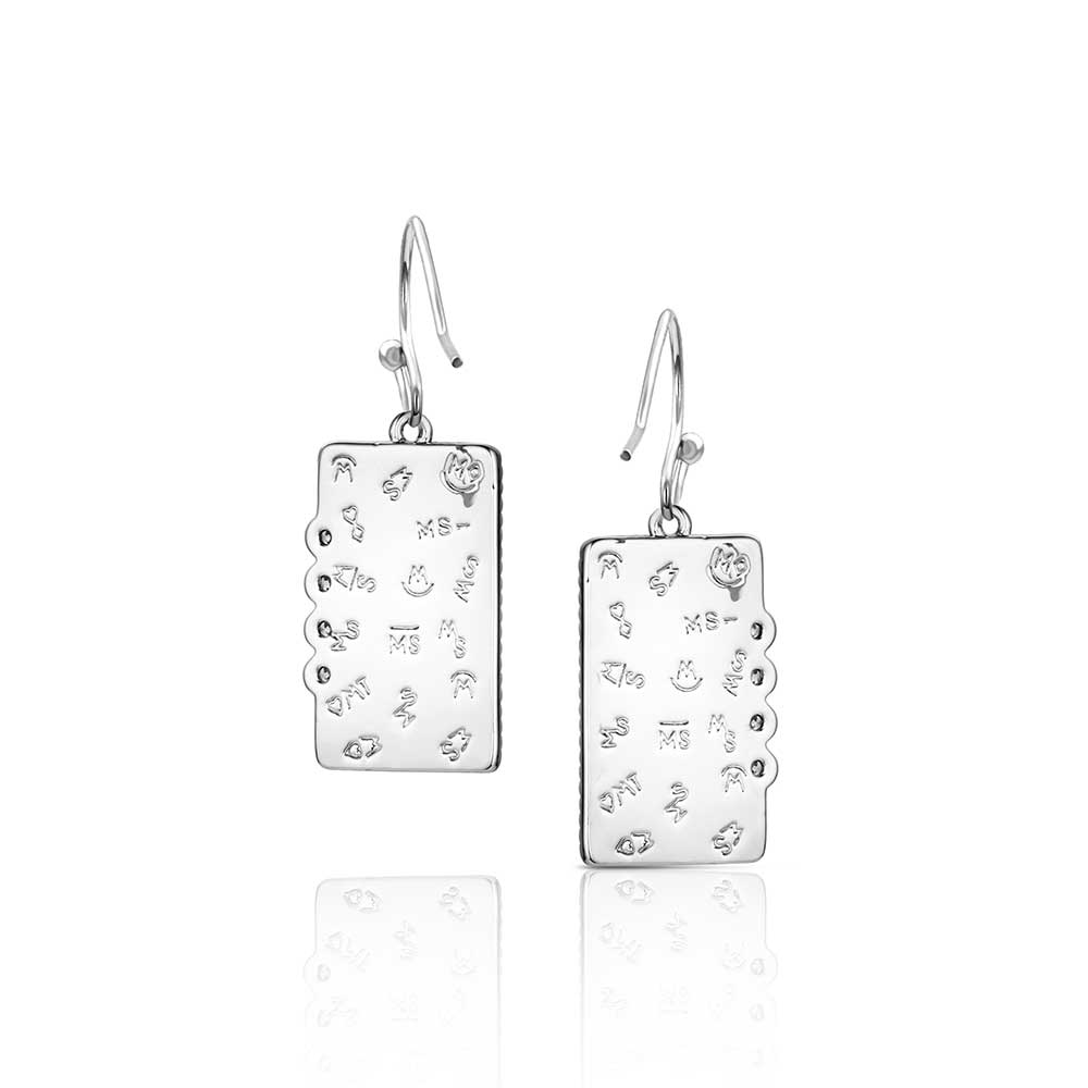 Pair of silver earrings with intricate designs on a white background