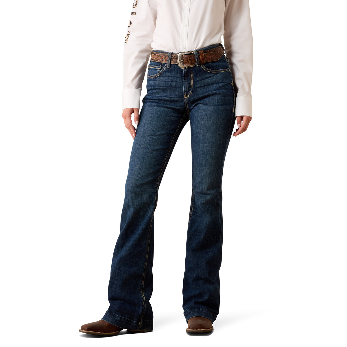 A model wearing dark blue western-style bootcut jeans with a brown leather belt, paired with a cream western shirt and brown boots, shown from the waist down on a white background.