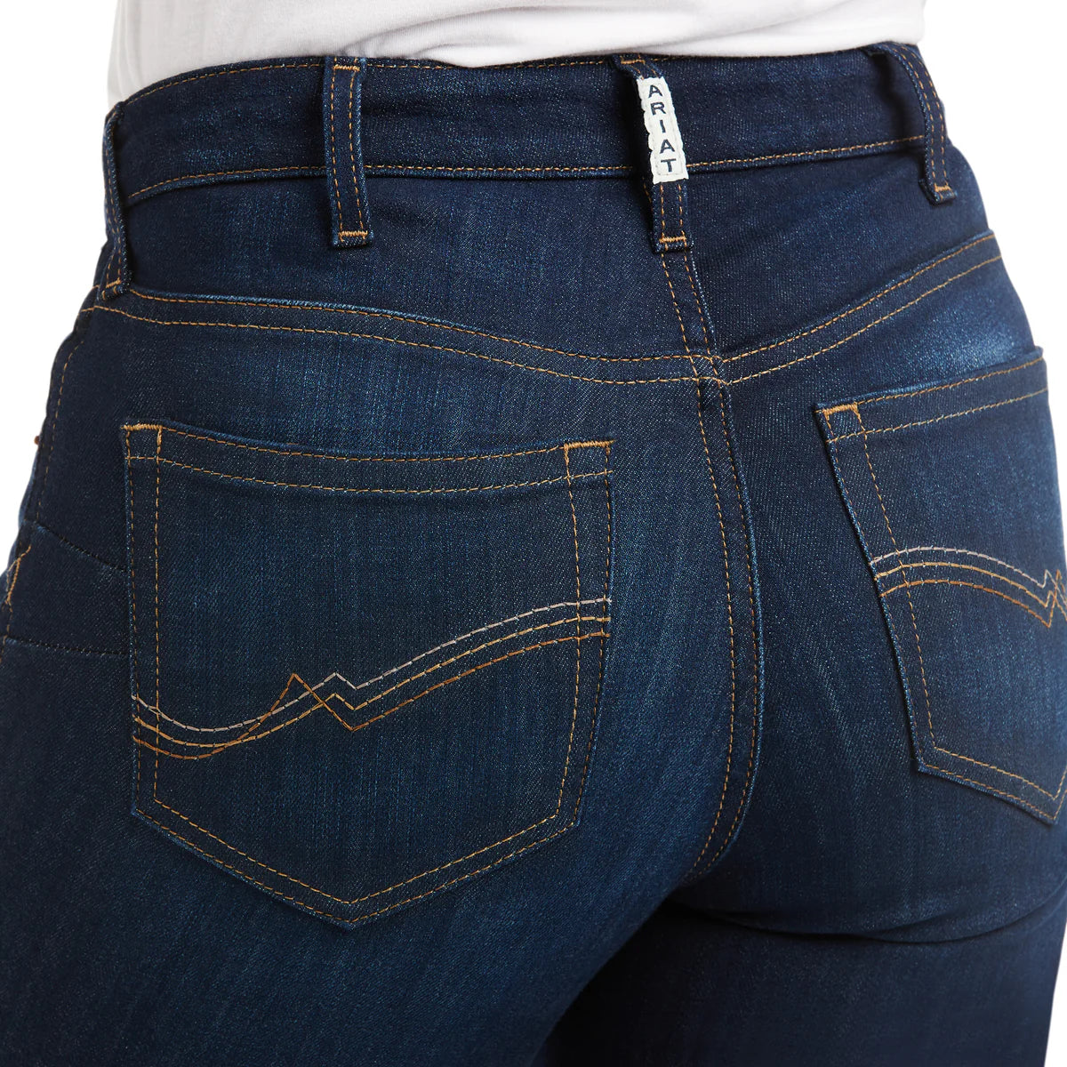 Close-up of blue jeans with Ariat branding on a white background