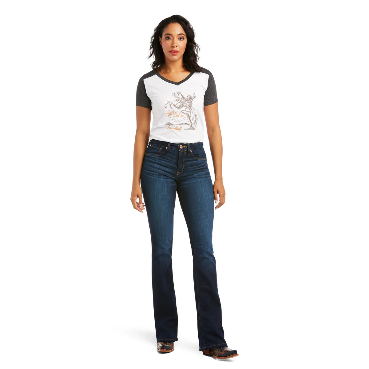 Woman wearing a graphic t-shirt and blue jeans on a white background