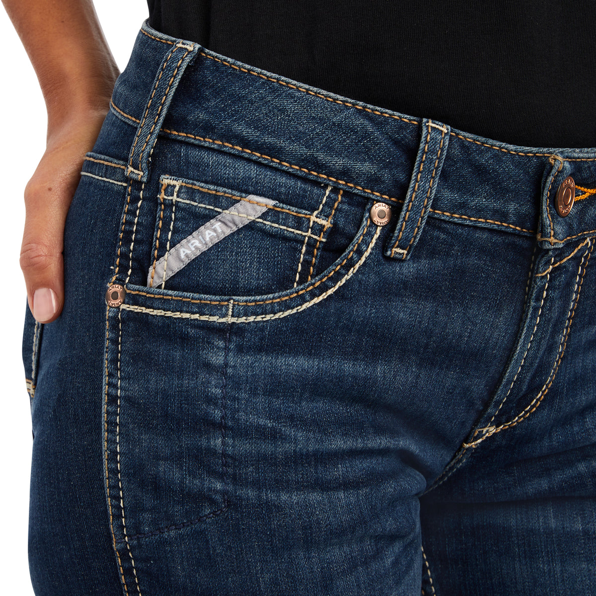 Close-up of blue jeans with a focus on the pocket area.
