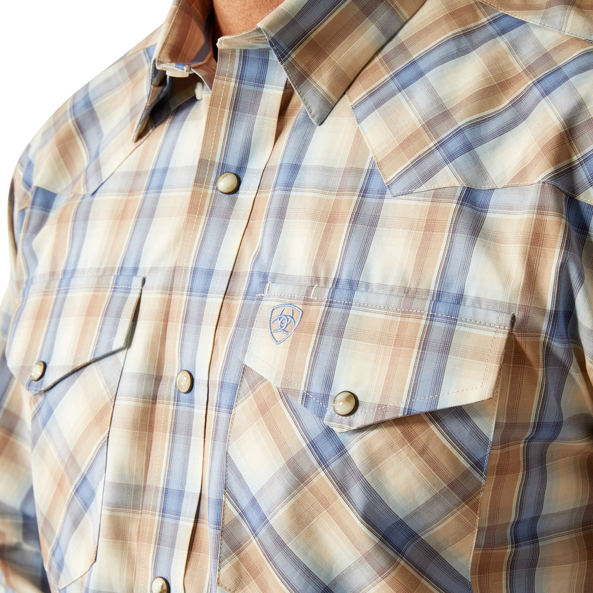 Ariat Men's Pro Series Clint L/S Snap Western Shirt. Close-up of a plaid shirt with buttons.