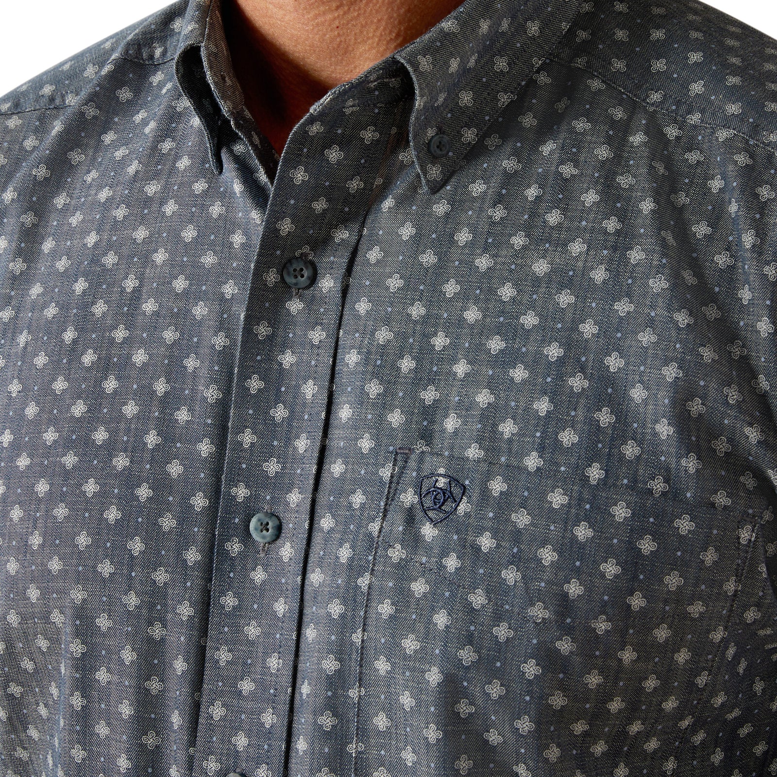Ariat Men's Chip L/S Western Shirt. A man wearing a long-sleeved geometric patterned Western shirt by Ariat, paired with blue jeans and a cowboy hat.