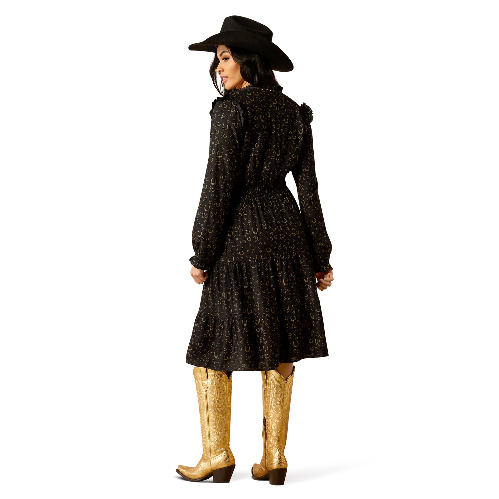 Ariat Women's Blinged Out L/S Western Dress. Person wearing a black patterned coat and hat, gold boots on a white background.