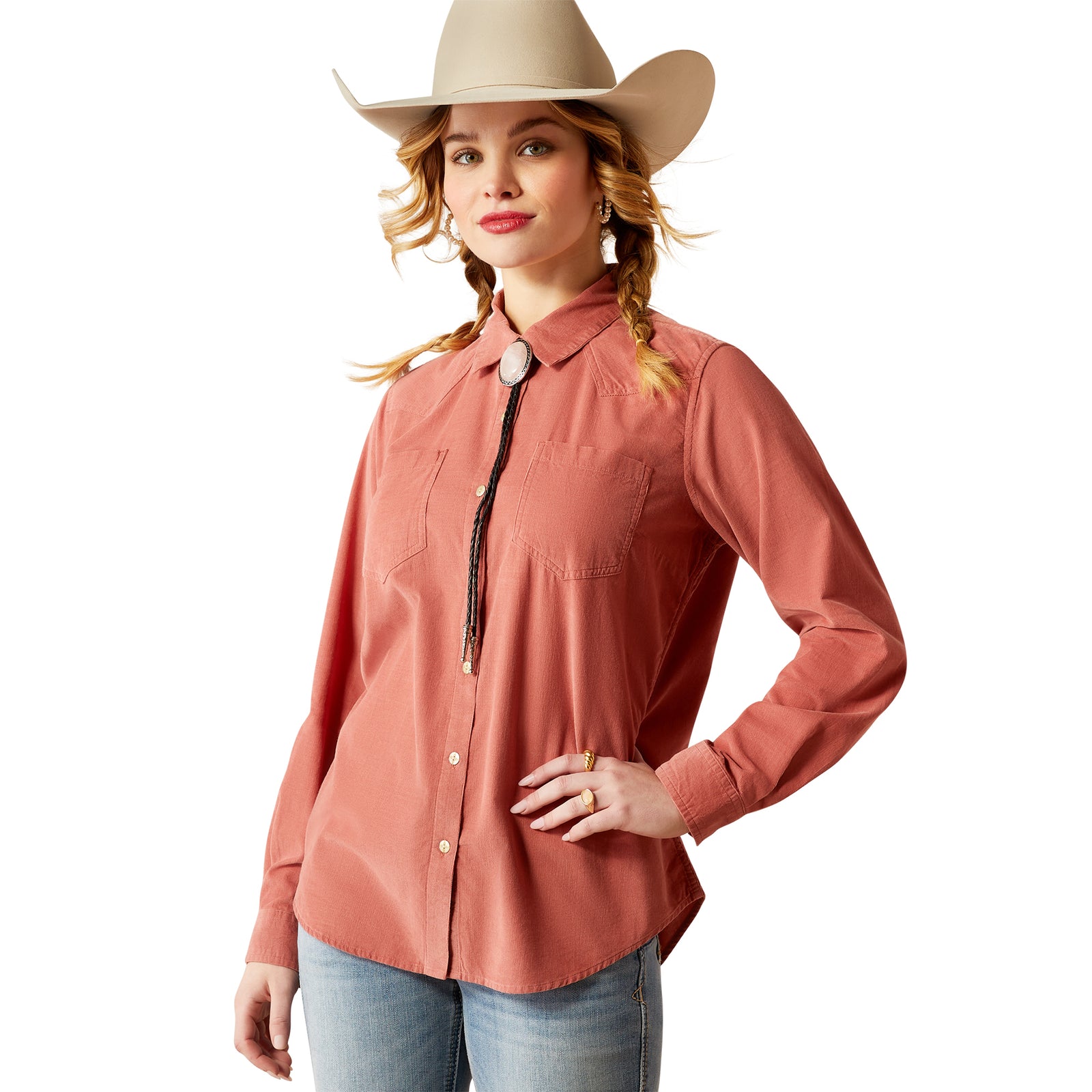 Ariat Women's Billie Jean Corded L/S Western Shirt. A woman wearing a pink long-sleeved western shirt with a pointed collar, button-up front, and a hat.