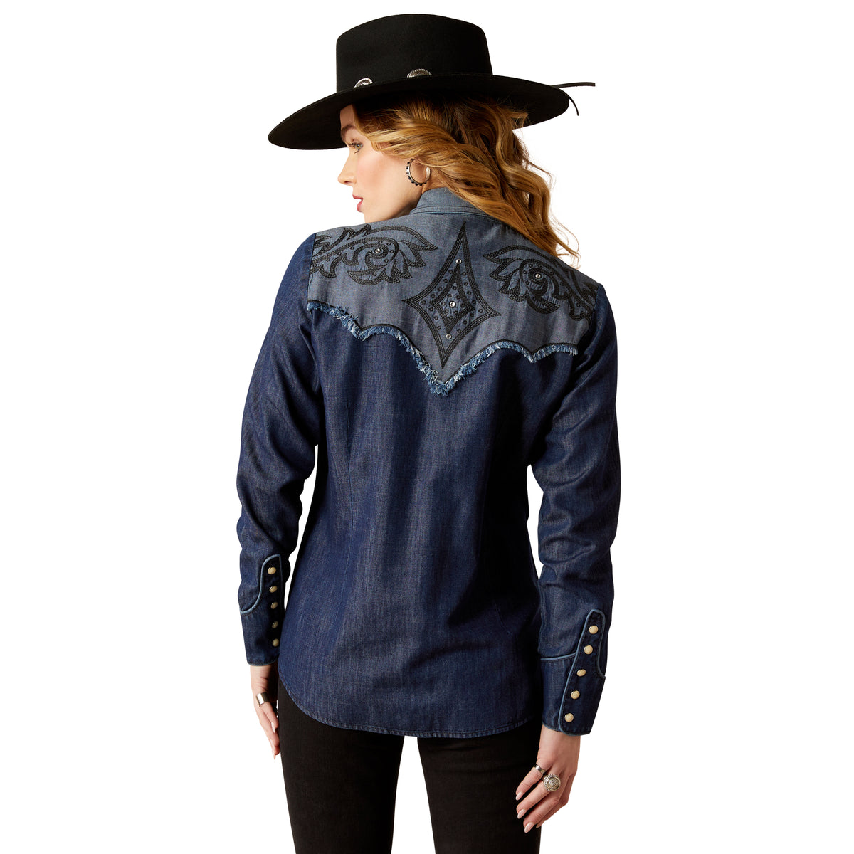 Ariat Women's Second Fiddle L/S Western Shirt. Person wearing a blue denim shirt with embroidered back design.