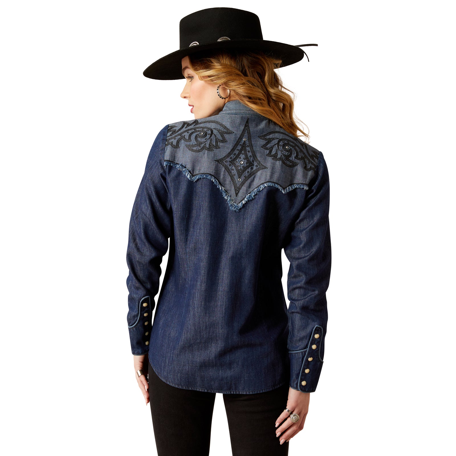 Ariat Women's Second Fiddle L/S Western Shirt. Person wearing a blue denim shirt with embroidered back design.