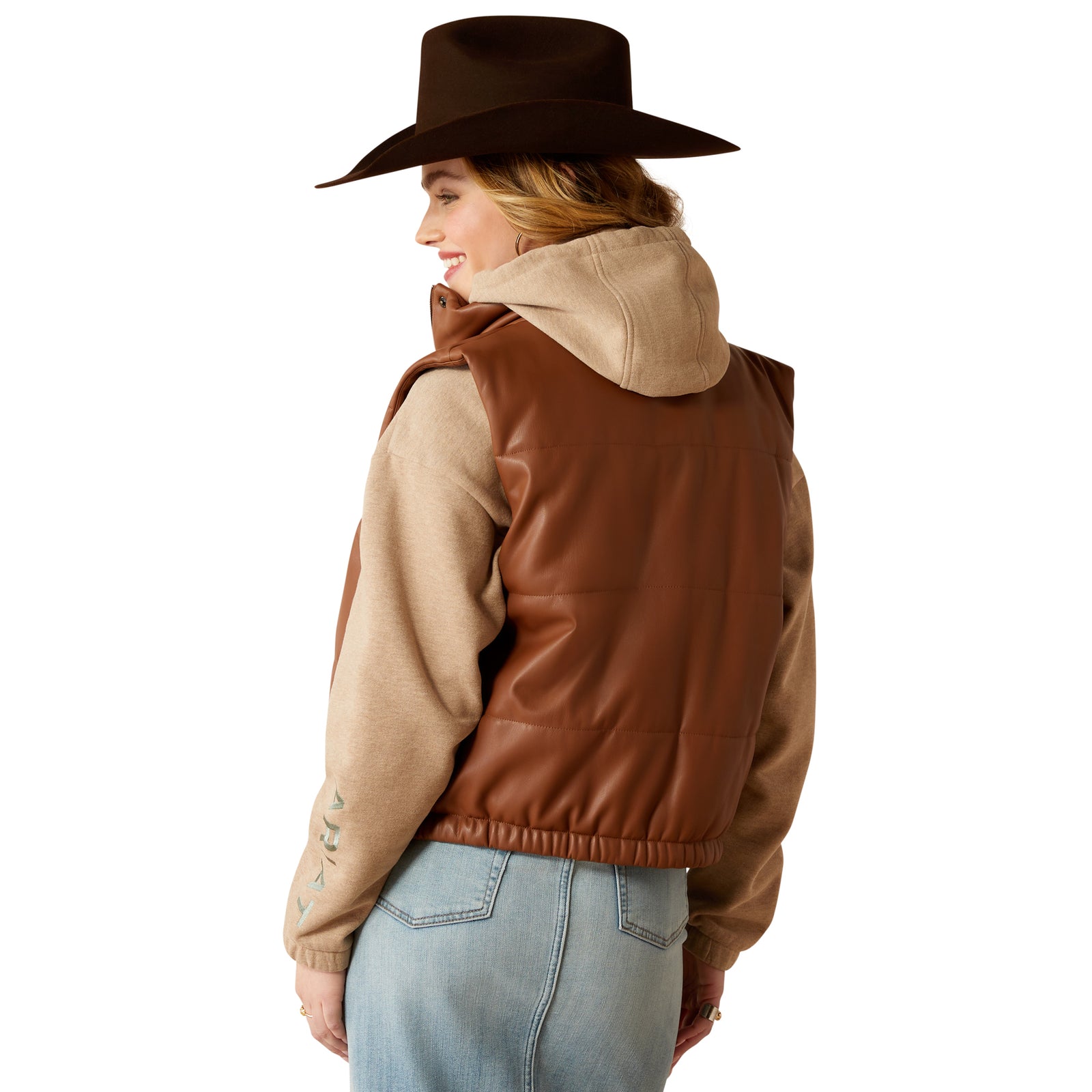 Ariat Women's Swirls Faux Leather Vest. Person wearing a brown leather jacket and hat, facing away from the camera.