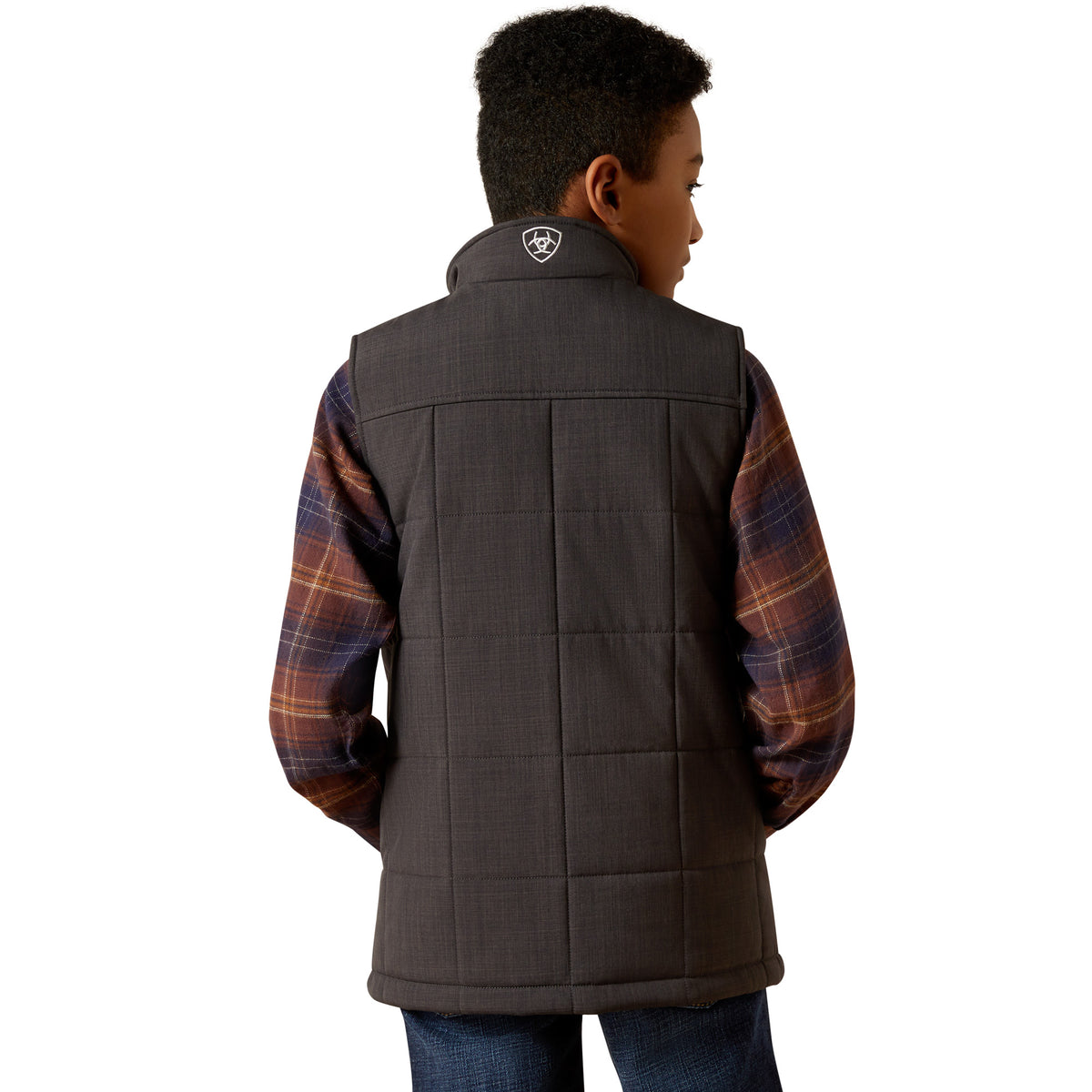 Child wearing a dark brown quilted vest over a plaid shirt on a white background