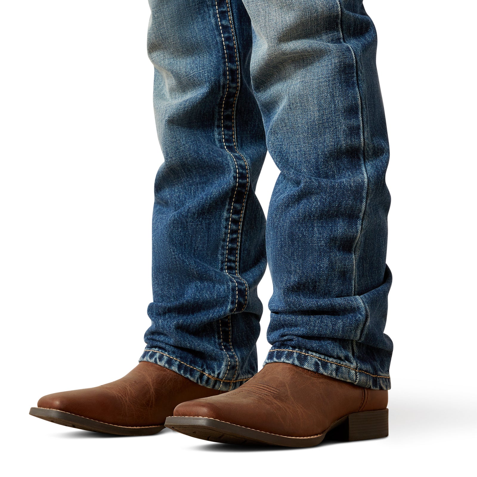Blue jeans and brown boots on a white background