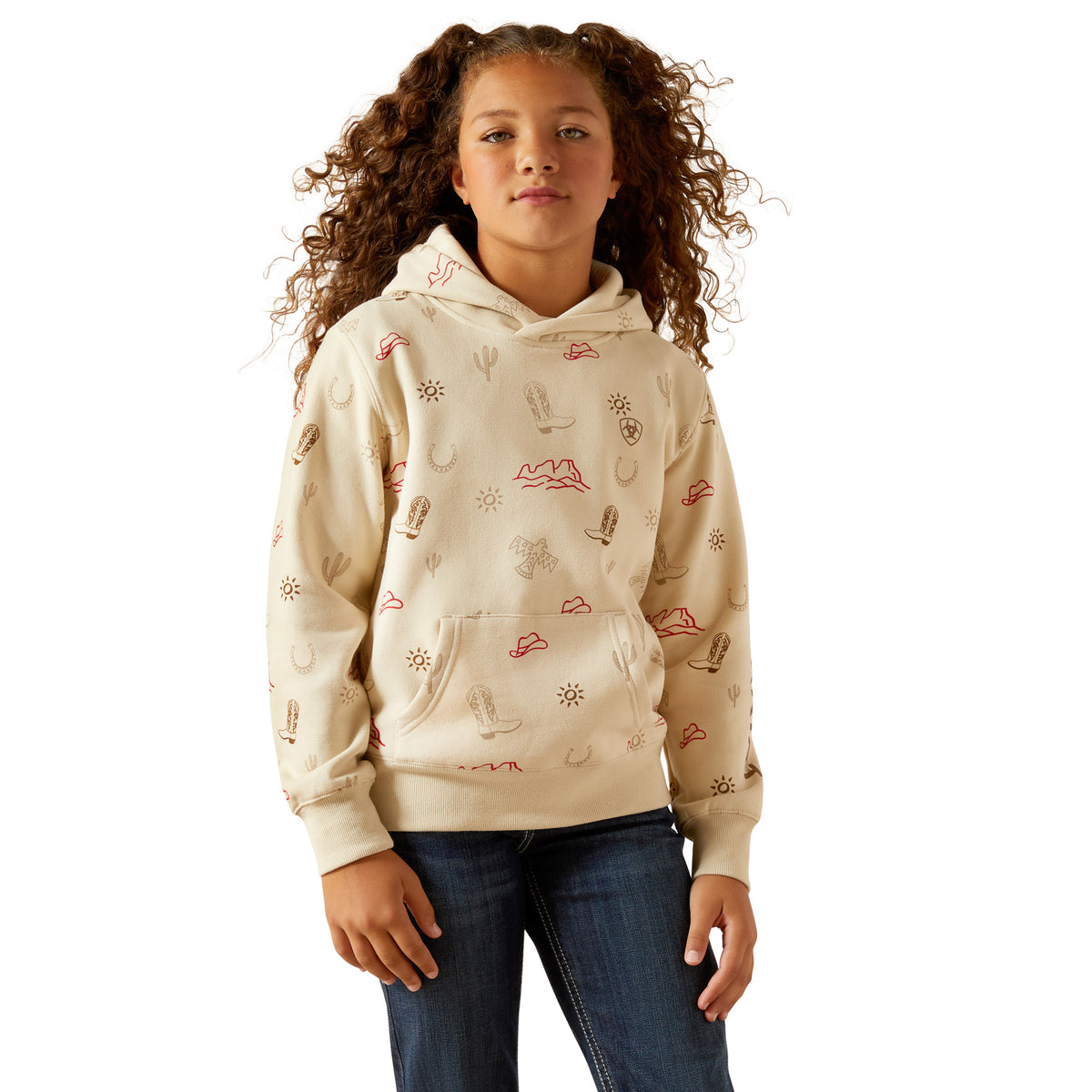 Young girl wearing a beige hoodie with cartoon designs on a white background