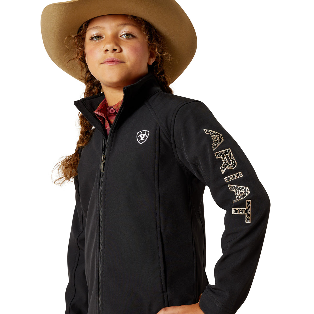 Child wearing a black jacket with branding and a cowboy hat on a white background