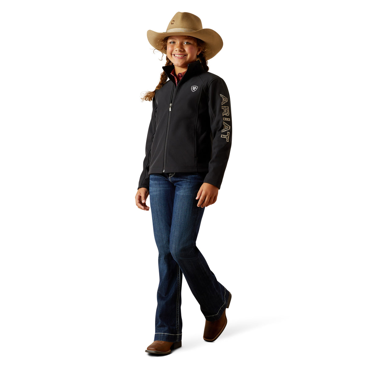 Person wearing a black jacket with a logo, blue jeans, and a cowboy hat on a white background