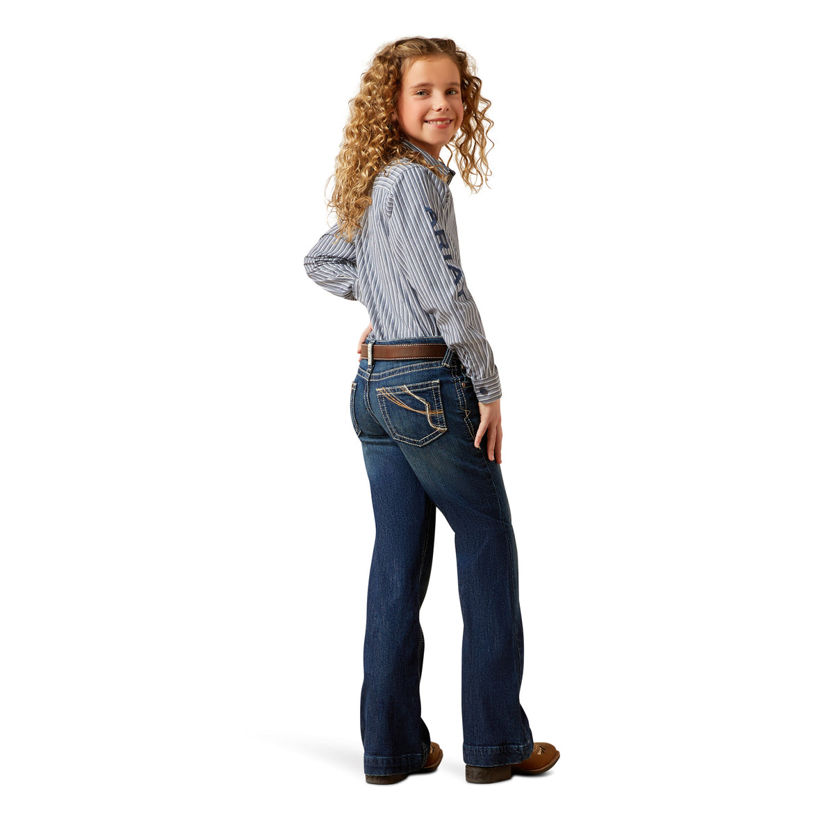 Young girl wearing a striped shirt and blue jeans on a white background