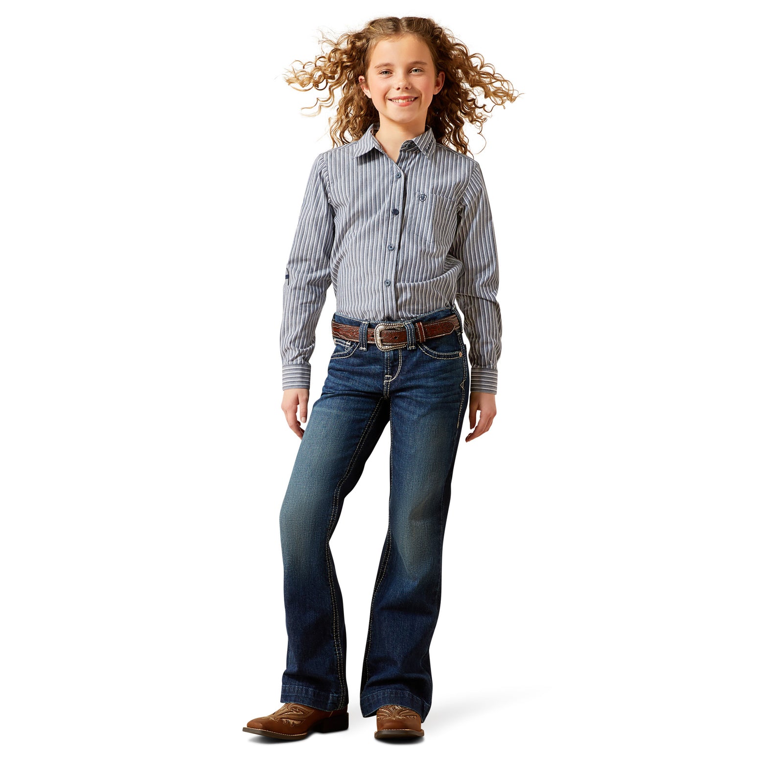 Young girl wearing a striped shirt and jeans on a white background