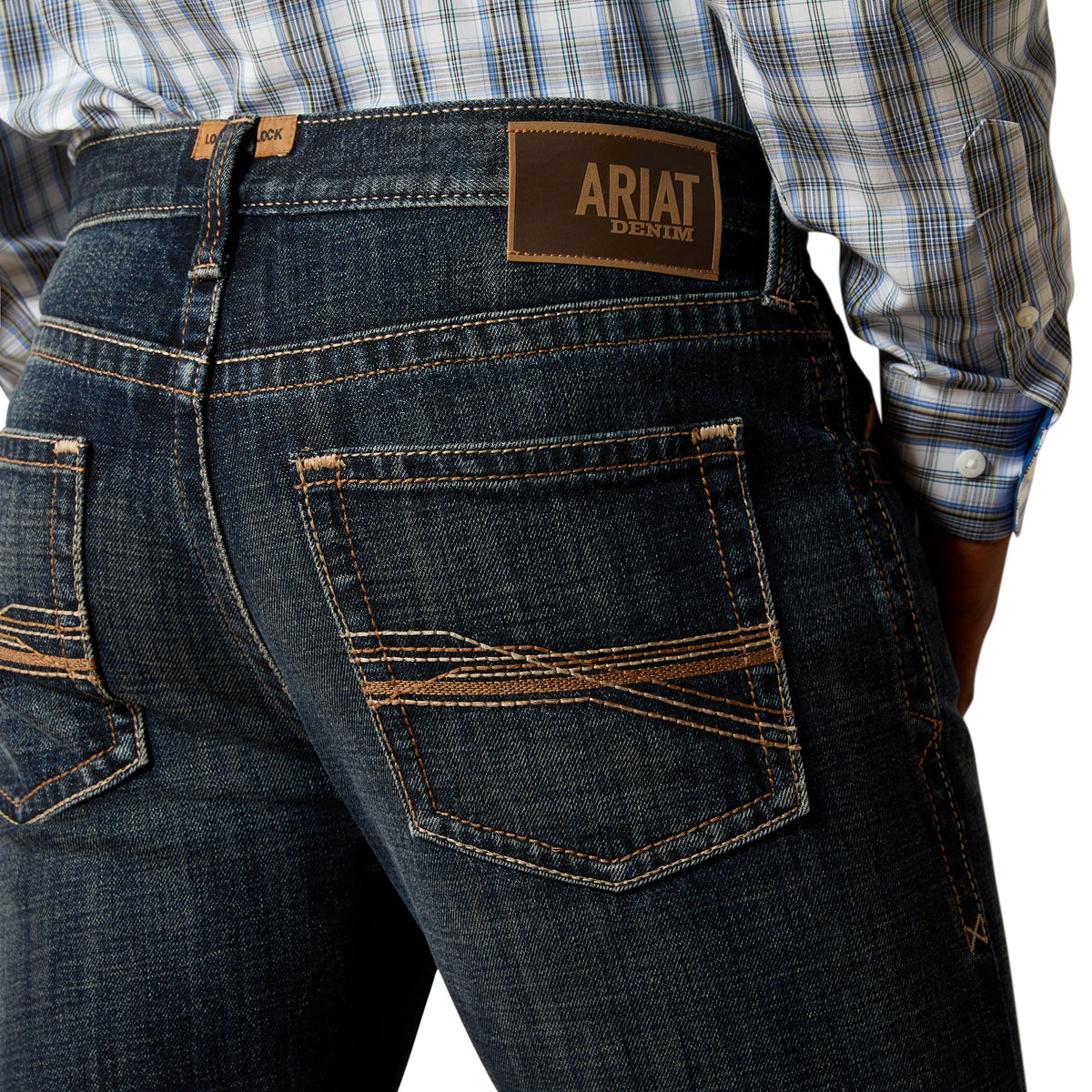 Ariat Men's M5 Keith Straight Leg Jean. Close-up of dark blue jeans with Ariat logo on a white background