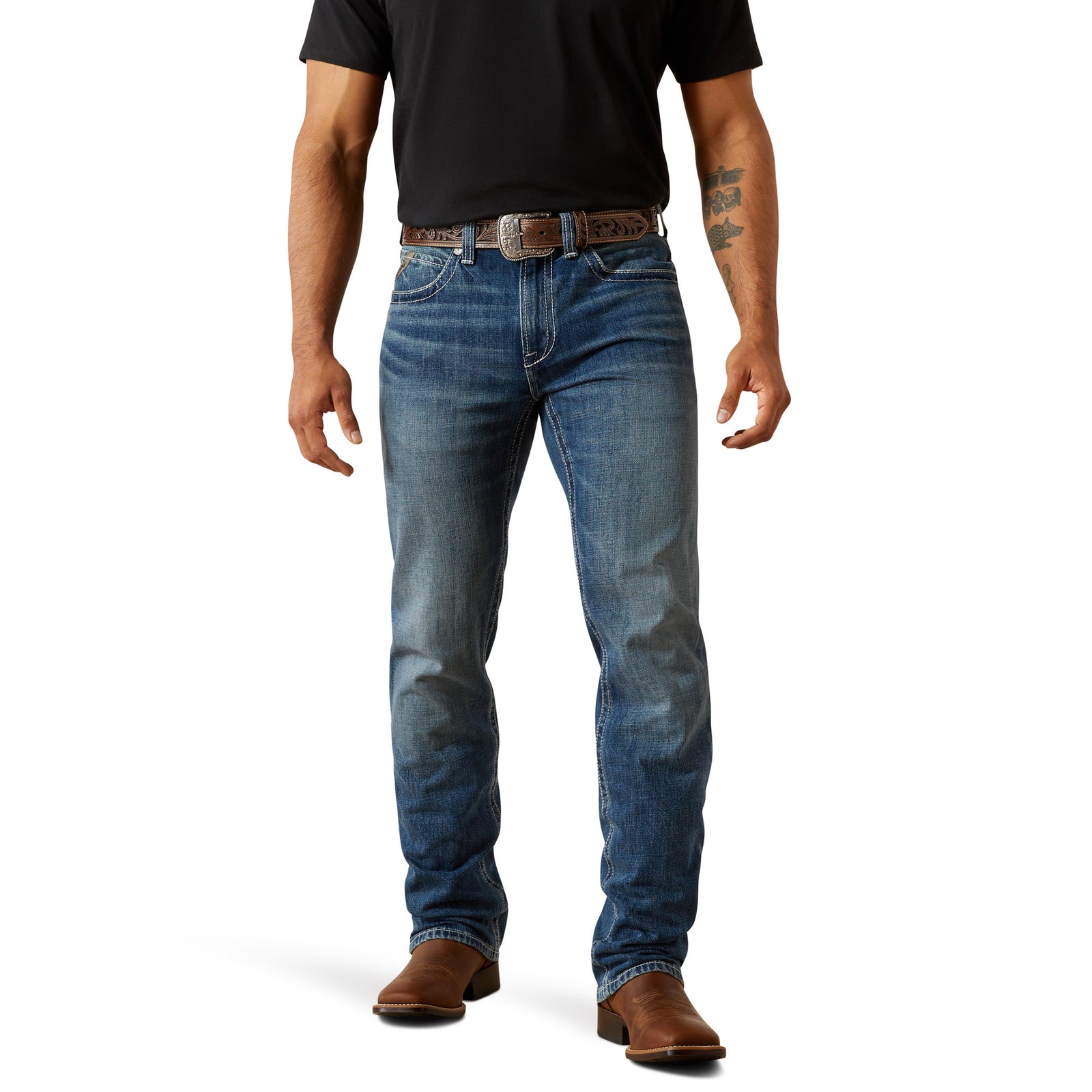 Ariat Men's M4 August Relaxed Straight Leg Jean. Person wearing blue jeans and a black shirt on a white background