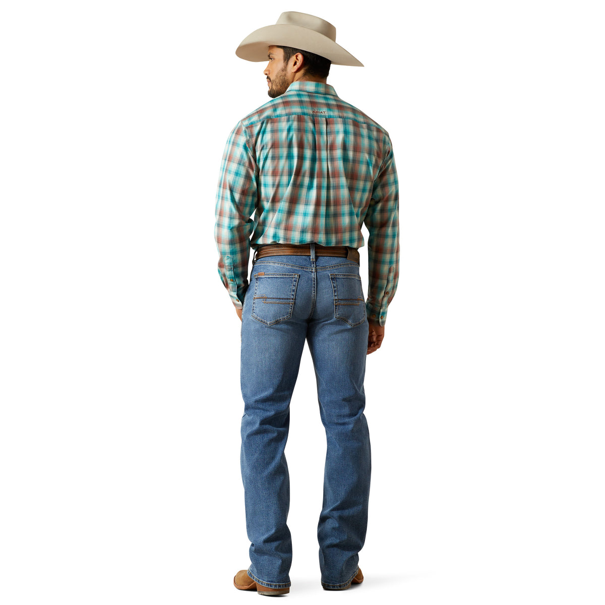 Ariat Men's M4 Pickett Relaxed Boot Cut Jean. Man wearing a plaid shirt and blue jeans with a cowboy hat on a white background