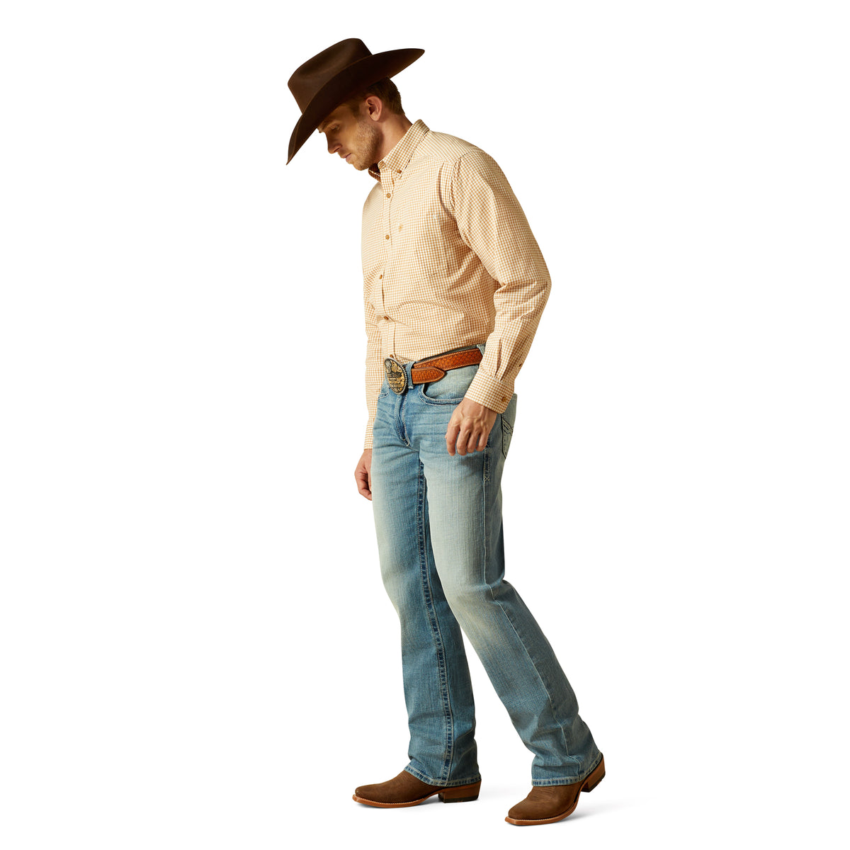 Man wearing a beige shirt, blue jeans, and a brown cowboy hat on a white background