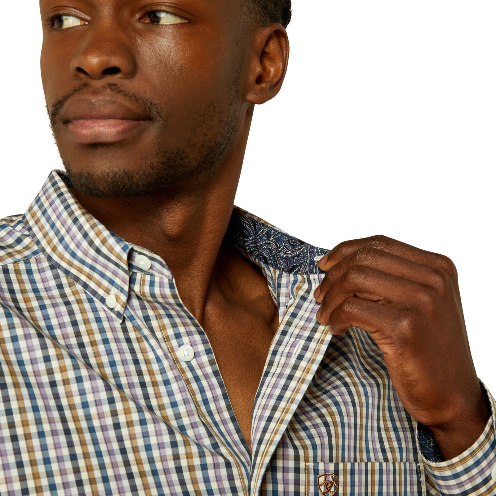 Man adjusting his checkered shirt collar against a white background