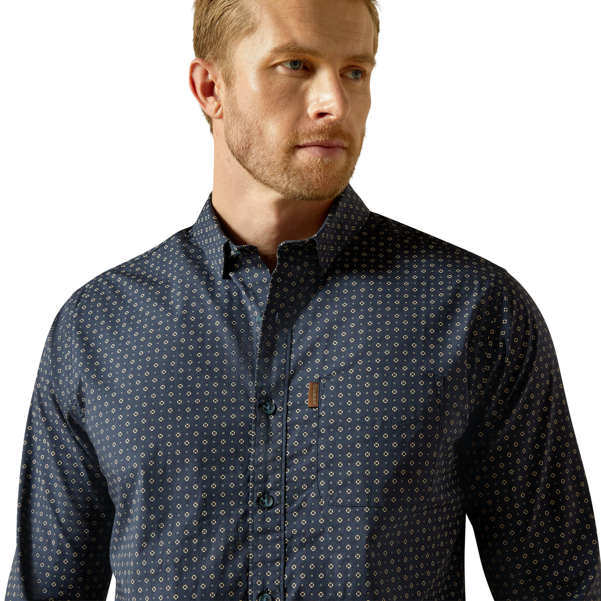Man wearing a dark patterned shirt on a white background