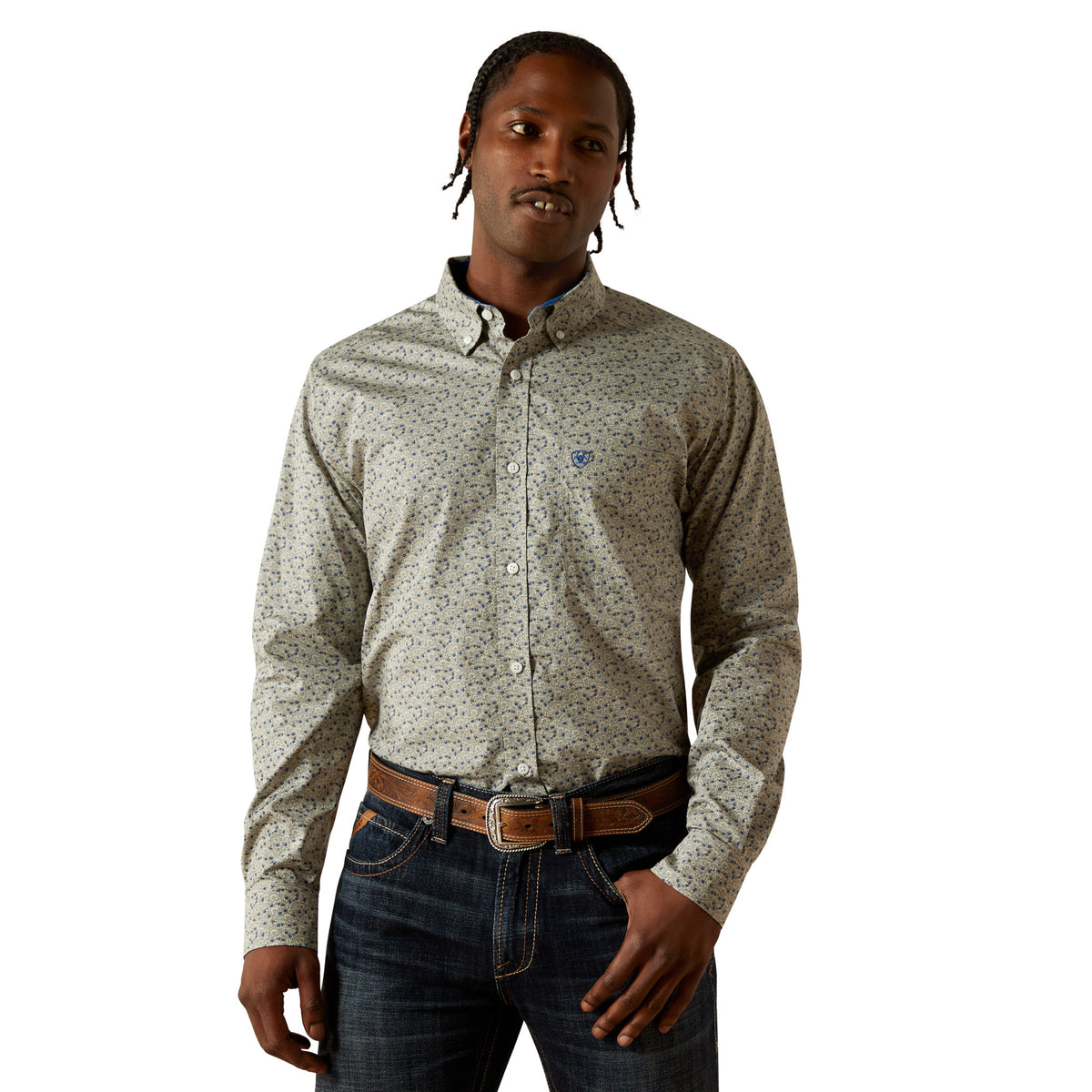 Man wearing a patterned shirt and jeans on a white background
