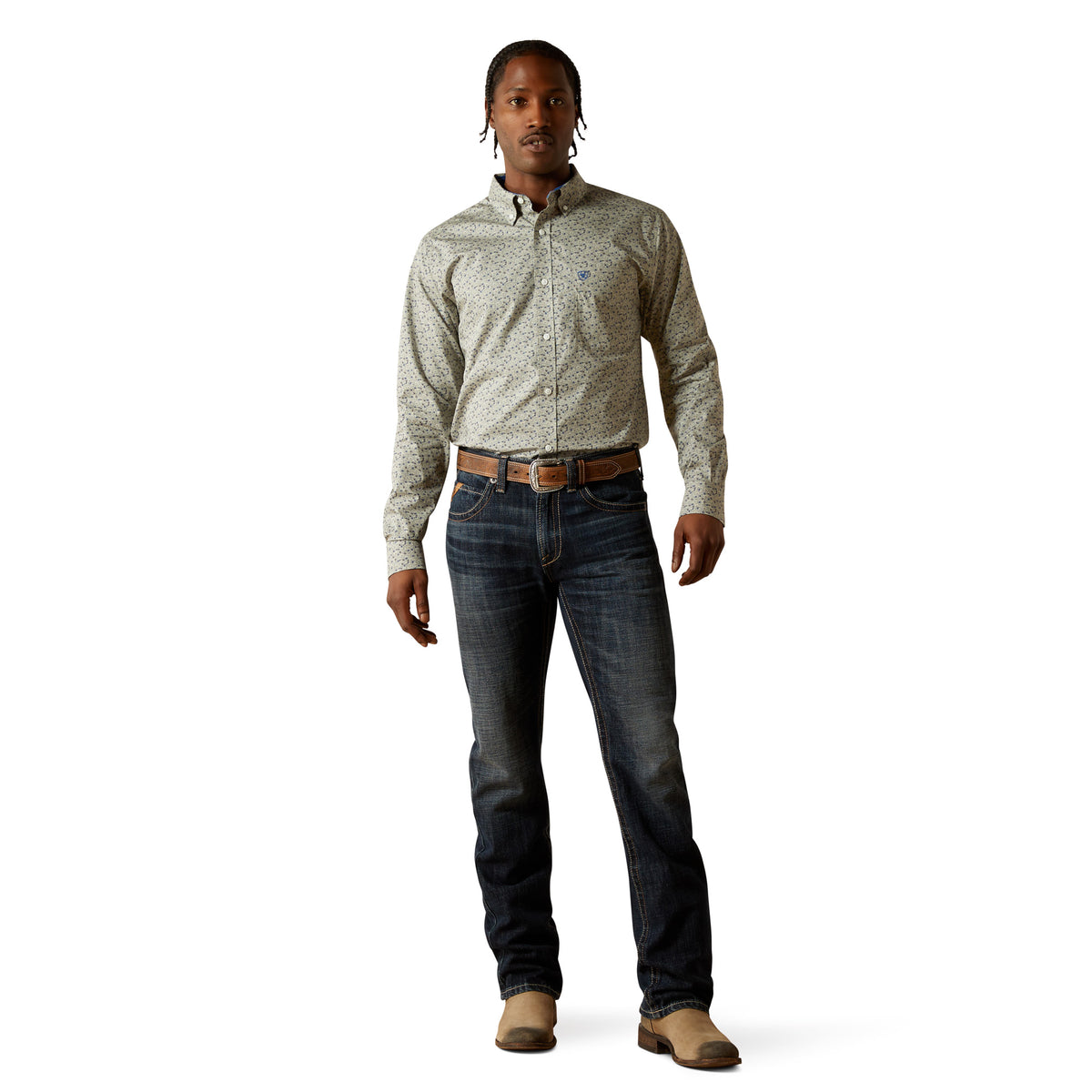 Man wearing a patterned shirt, jeans, and boots on a white background