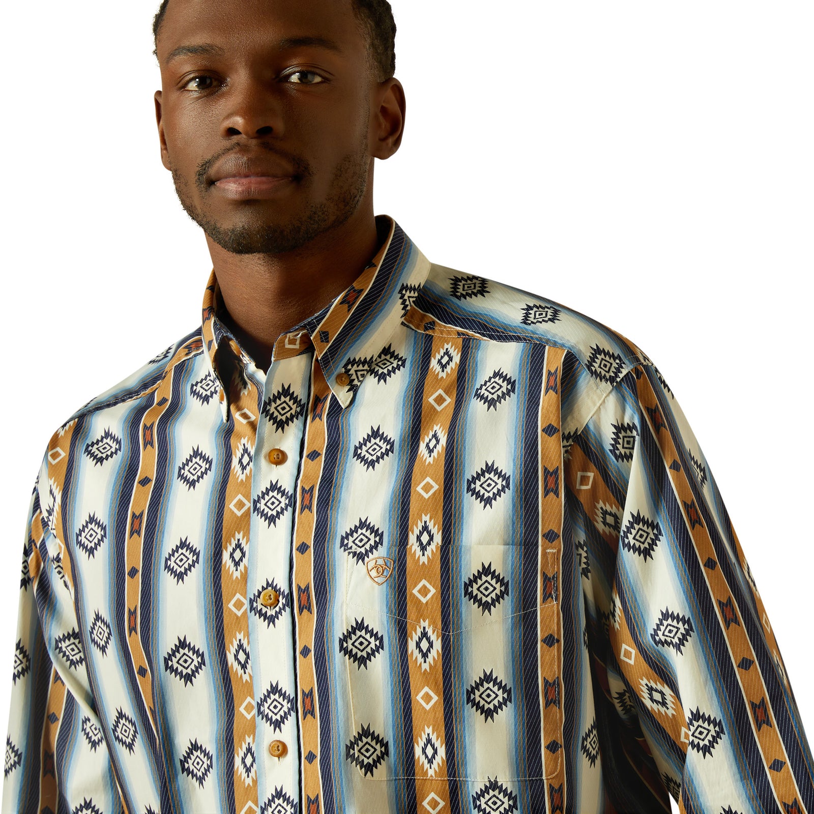 Man wearing a patterned shirt and jeans on a white background