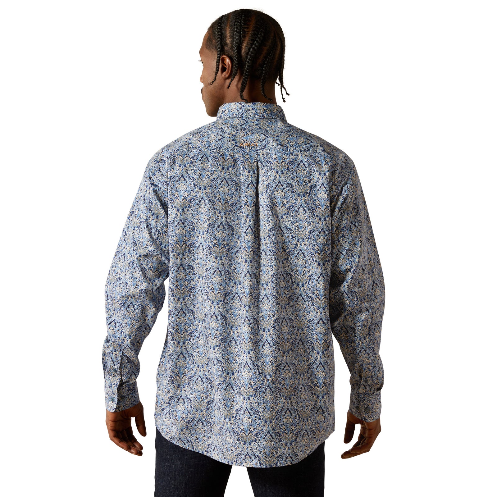 Person wearing a patterned shirt on a white background