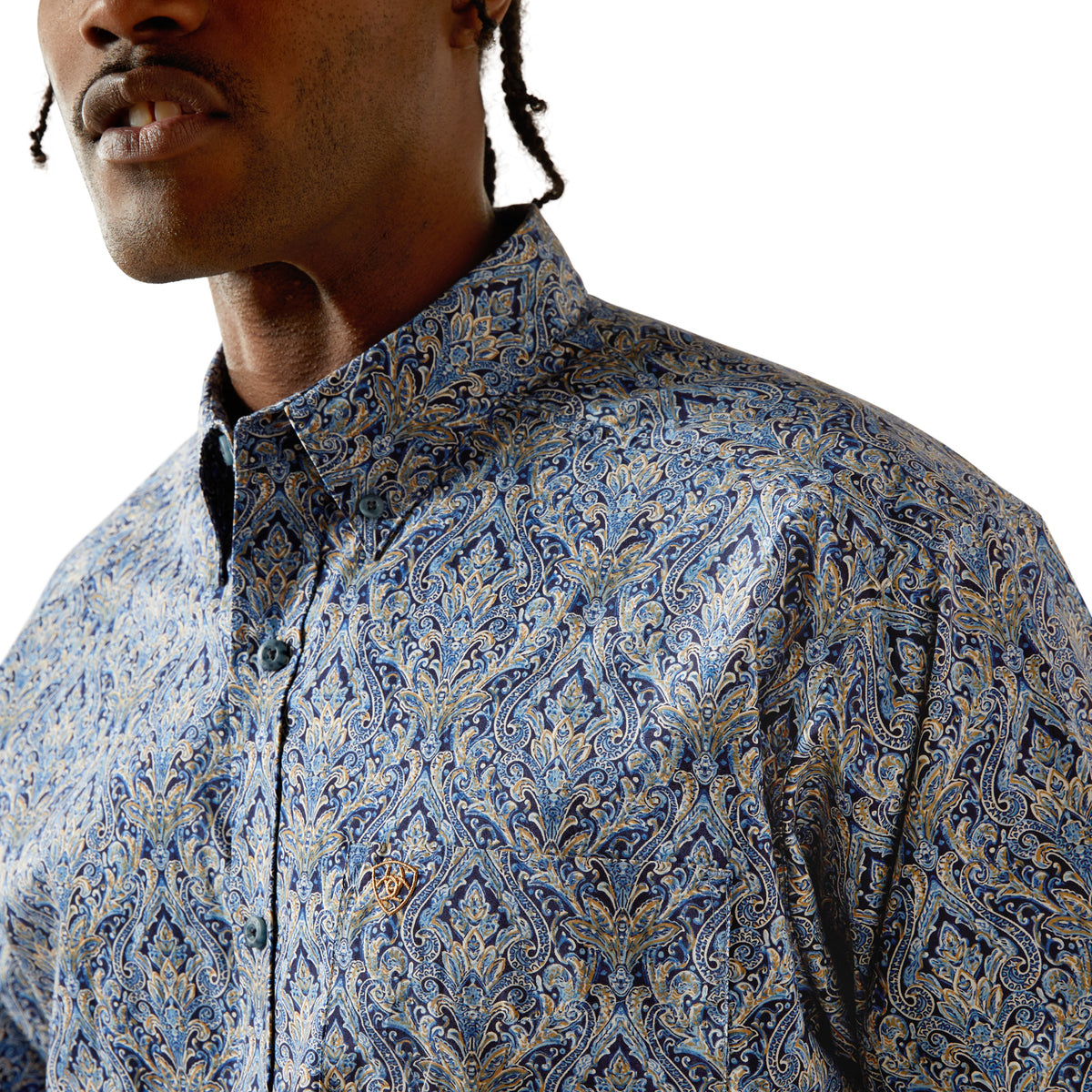 Man wearing a blue patterned shirt against a white background