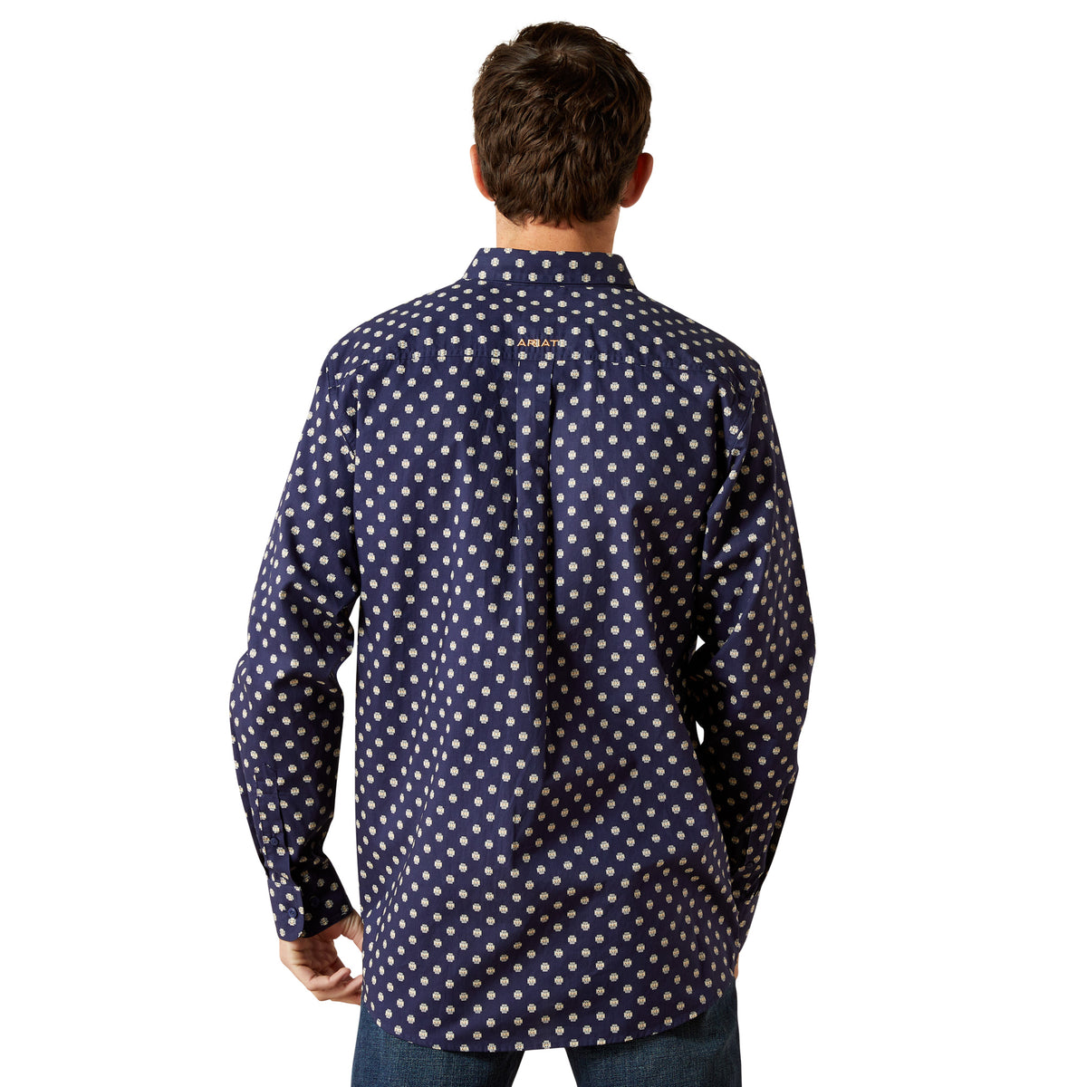 Man wearing a navy blue shirt with white pattern on a white background