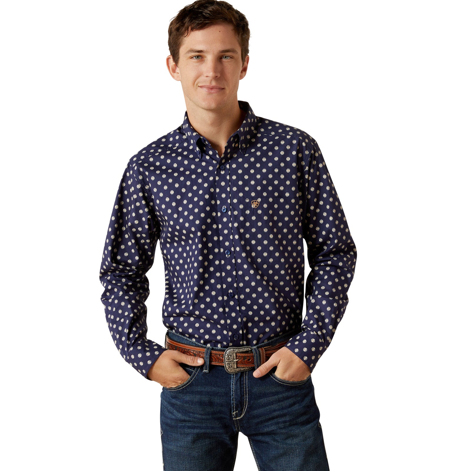 Man wearing a navy blue shirt with white polka dots and jeans on a white background