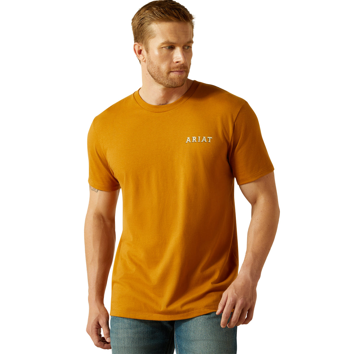 Ariat Men's Scorpion Seal T-Shirt. Man wearing a mustard yellow Ariat t-shirt on a white background