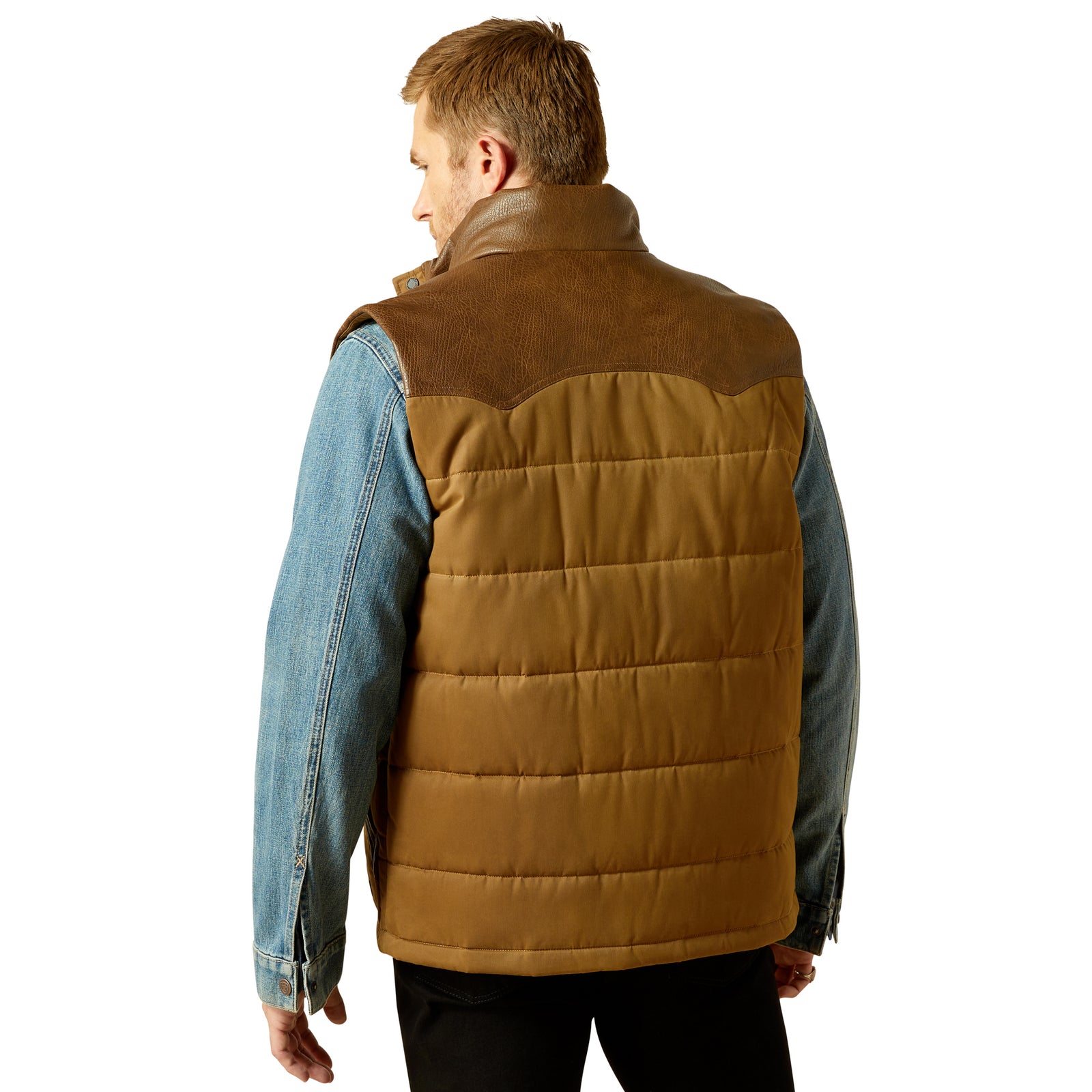 Man wearing a brown quilted vest over a denim jacket on a white background