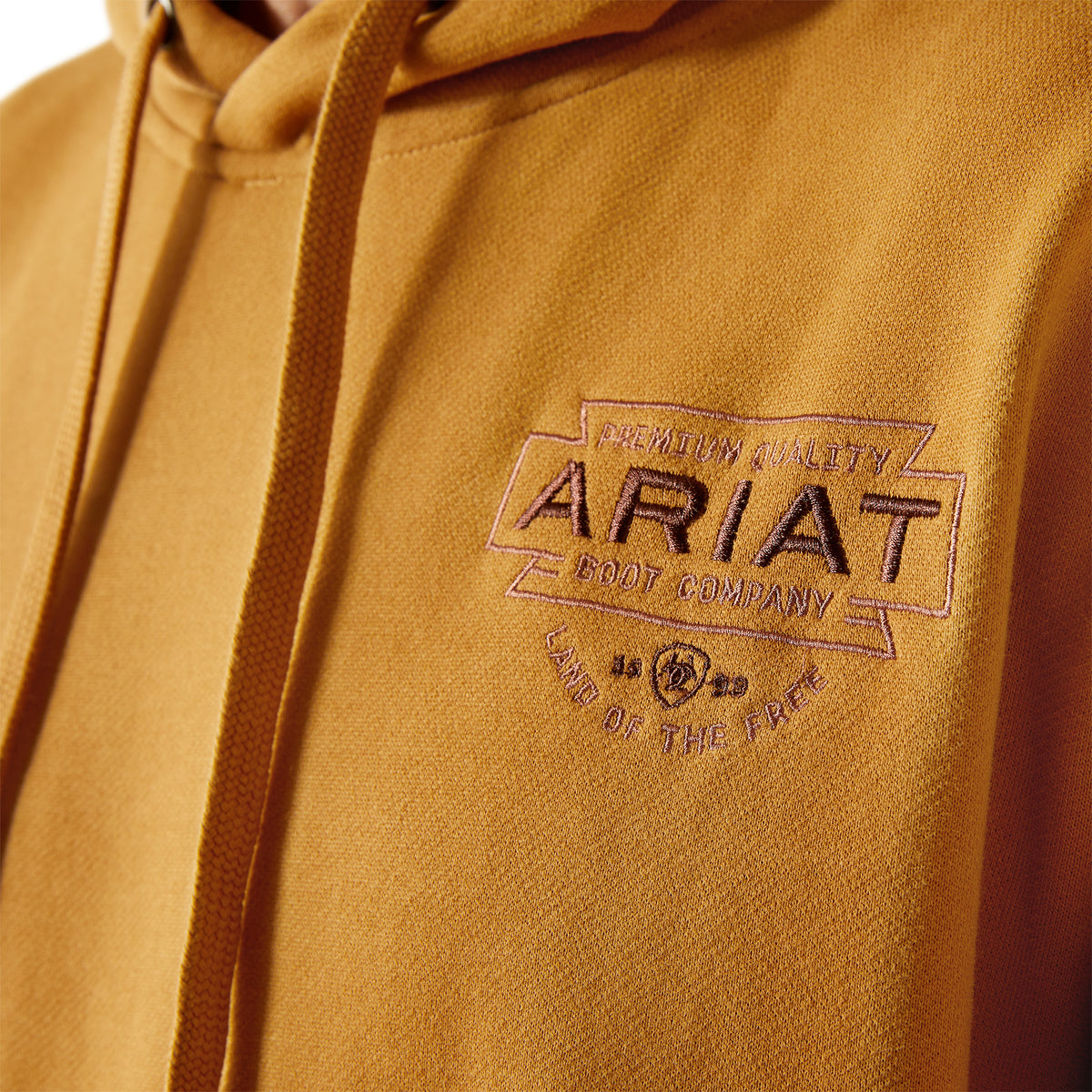Brown hoodie with Ariat logo on a brown background
